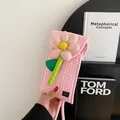 Pink quilted woven phone bag with a 3D floral accent and hand-made label detail - Pink
