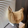 Beige straw saddle shoulder bag with brown leather strap in a minimalist home setting - Beige