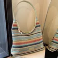 Bohemian striped handwoven hobo bag with rainbow patterns and green shoulder strap - Colorful