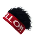 Macro detail of red knit beanie with black faux hair wig and white HELLO text - One Size / Red With Black Wig