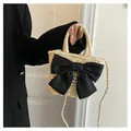 Natural straw bucket bag featuring a large black silk bow and round top handles - Large Black Bow Style / Off White