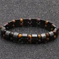 Double-row tiger eye and hematite beaded bracelet on black textured background - Tiger's Eye