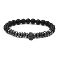 Close-up of matte black beads and a metallic skull charm on a gothic style men's bracelet - Black Skull Matte Stone Bracelet