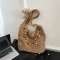 Bohemian straw shoulder bag featuring colorful pom-poms and a beaded strap detail - Khaki