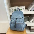 Blue denim drawstring backpack with flap closure and front zipper pocket for casual use - Light Blue