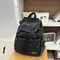 Vintage washed black denim backpack with drawstring closure and minimalist flap design - Black