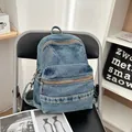 Retro washed blue denim backpack with multi-pocket design and metallic zippers - Light Blue