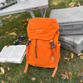 Bright orange waterproof hiking backpack with adjustable buckles on grass lawn - Orange