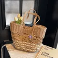Handwoven straw tote bag with a purple floral charm and decorative white tulips - Khaki