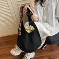 Black woven tote bag with colorful bohemian floral embroidery on a wide shoulder strap - Black Without Lining
