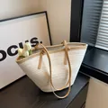 Beige woven straw tote bag with khaki leather handles and minimalist focus background - Off White