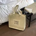 Beige woven straw tote bag with black Love Life embroidery and dual shoulder straps - Beige