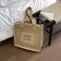 Beige large straw tote bag with black LOVE LIFE embroidery for summer beach vacations - Khaki