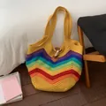 Macro detail of rainbow knit tote bag with colorful V-stripes and brown leather buckle - Yellow