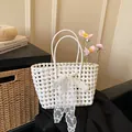 White woven basket shoulder bag with lace bow decoration and pink floral accents - With Silk Scarf / White