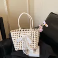 Chic beige woven tote bag featuring a large lace bow and floral accent for seaside vacation - With Silk Scarf / Off White
