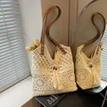 Cream crochet knit beach bag with hollow floral pattern, tassels, and leather straps - Beige