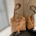 Beige crochet woven bag with brown leather strap, tassel detail and cutout flower pattern - Khaki