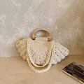 Beige shell-shaped woven cotton bag with wooden handle and adjustable shoulder strap - Off White