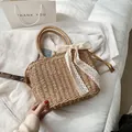 Handwoven straw tote bag with cream lace bow and round handles for summer vacations - Khaki