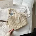 Straw beach tote with lace bow and round woven handle for summer holiday - Off White
