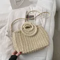 Beige woven straw shoulder bag with ring handles on soft corduroy fabric background - Beige