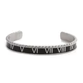 Detail of silver stainless steel cuff bracelet with black enamel Roman numerals and knurled edge - Black Roman Numeral