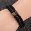Detail of matte black beaded bracelets with gold-plated zircon charms for men - Gold