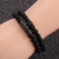 Close-up of men's matte black stone bead bracelets with gothic charms on wrist - Carved Tube and Cube Pave Style / Gunmetal