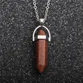 Macro shot of brown goldstone hexagonal point pendant on silver chain necklace - Gold Sandstone