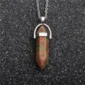 Macro shot of green and red Unakite hexagonal prism stone pendant on silver chain - Green Grass