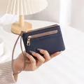 Detailed view of deep blue litchi grain leather wallet with double gold zippers - Sapphire Blue