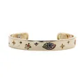Detail showing the Evil Eye motif and colored cubic zirconia on a gold cuff bracelet - Evil Eye Bangle