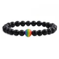 Macro shot of dark blue goldstone bracelet with a rainbow striped bead on white background - Blue Sandstone