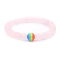 Pink quartz beaded bracelet with a single colorful rainbow stripe bead on white background - Rose Quartz