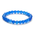 Close-up of translucent blue agate beaded bracelet with natural textures and polished finish - Blue Chalcedony