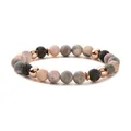 Armband aus rosa Zebra-Stein mit schwarzer Lava und roségoldenen Distanzstücken auf weiß - Mattierte Ausführung / Natürliche Lava/Rosa Zebra