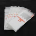 Transparent lip balm self-seal bag with white lace pattern and orange ribbon design - 100 Pieces/Pack (5x10+3cm) / White with Rose Print