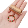 DIY jewelry kit with gold spring coil and colorful transparent beaded ring on palm - Memory Wire Ring Accessories / Gold
