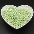 Perles en imitation ABS vert clair dans un bol en céramique en forme de cœur pour DIY - Vert clair