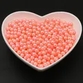Perles rondes corail nacrées dans coupelle coeur pour création de bijoux DIY - Rose Orangé