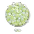 Detail of mint green resin cat-eye beads with silk luster in a silver tray - Yellow Grey