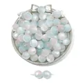 Detail of blue and pink cat eye resin beads on a silver tray for DIY jewelry making - Blue Pink