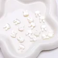 Cute bunny shaped natural shell charms for jewelry making with iridescent luster on a tray - Rabbit Head (Horizontal Hole)