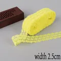 Bright yellow lace ribbon 2.5cm wide with intricate floral cutout pattern for DIY sewing - Yellow