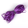 Bundle of glossy deep purple satin ribbon for DIY crafts secured with a green rubber band - Purple