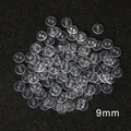 Bottoni rotondi trasparenti da 9mm a 2 fori per camicie e artigianato su sfondo nero - Diametro 9mm x Spessore 2mm