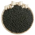 Matte black glass seed beads for DIY jewelry displayed in a vintage decorative dish - Black