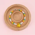 Colorful beaded bracelet with yellow bird charm on natural pine wood display tray - Beech Round Groove Tray