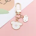 Detail of cute white enamel smiling cloud and puppy charms on a golden metal keychain - Cloud Style